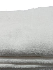 Stack of white towels on a dark surface with a blurred background